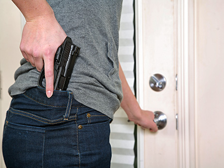 Armed woman with pistol opening front door